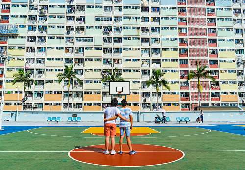 basketball court minimalist photography of two men standing on basketball court looking upwards sports
